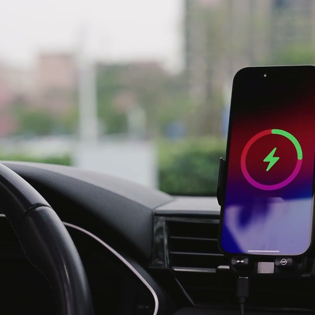 Phone charging wirelessly in the car phone holder
