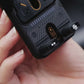 Hand holding the auto-clamping car phone holder